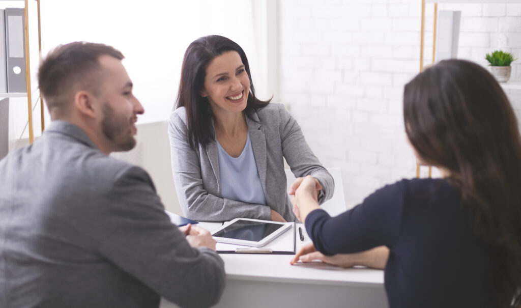 A positive realtor handshaking closing